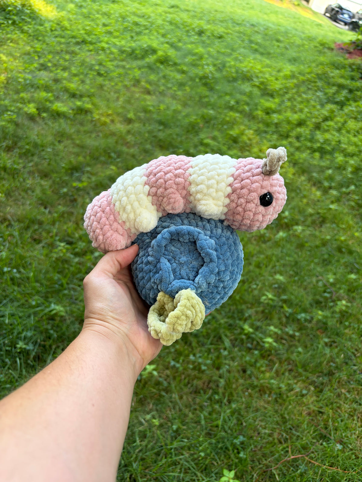 crochet caterpillar on a blueberry plush